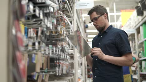 man shopping for tools at a hardware store