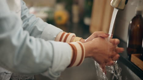 washing hands in kitchen sink