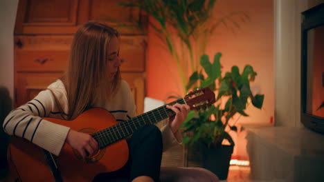 woman playing guitar writing song composing music