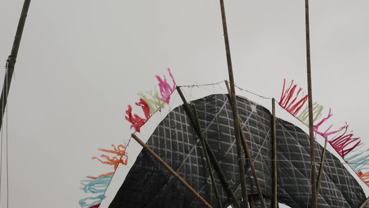 Backside structure of a giant kite with fluttering streamers in Sumpango Guatemala