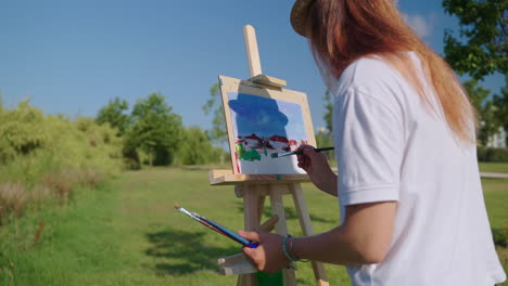 woman painting a landscape in a park