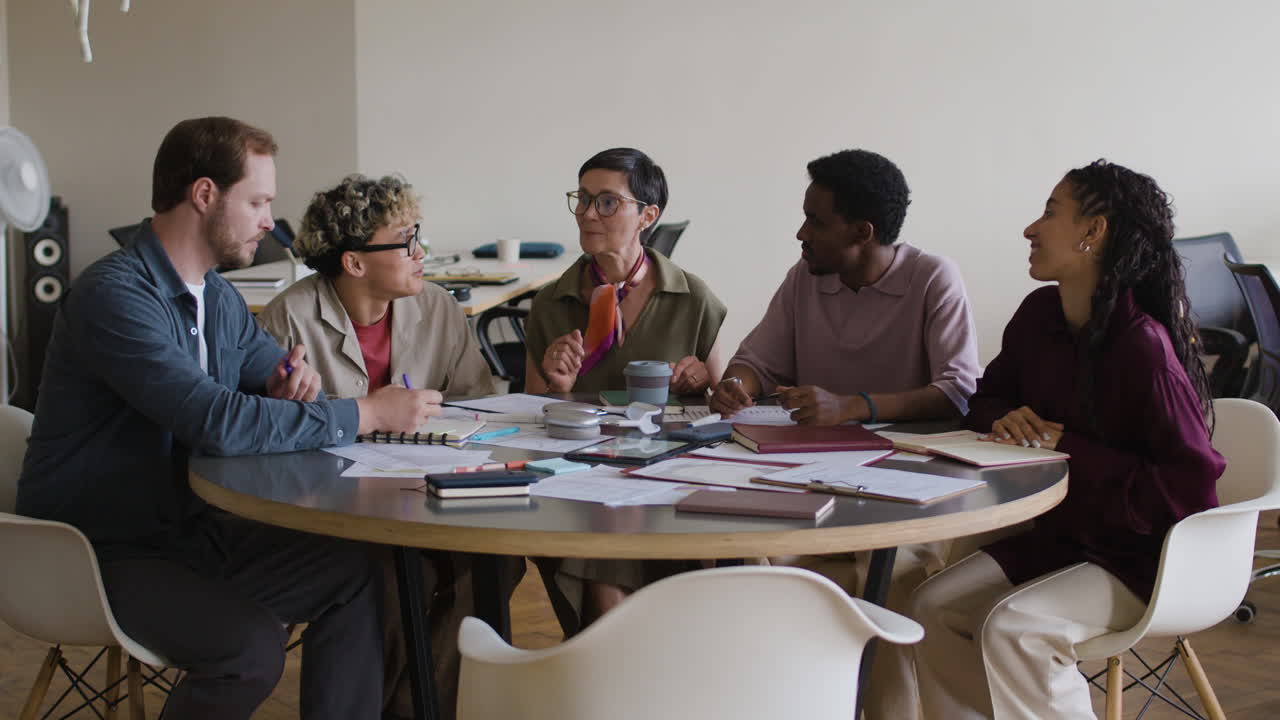 Diverse professionals engaging in a collaborative meeting around a circular table