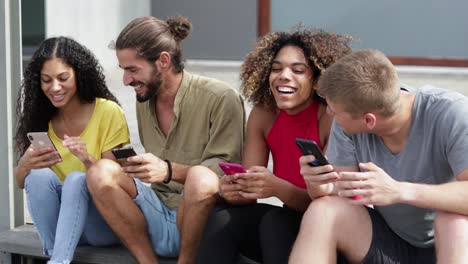 happy friends using smartphones