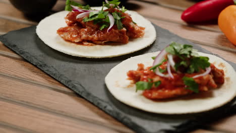 two delicious tacos on a slate plate