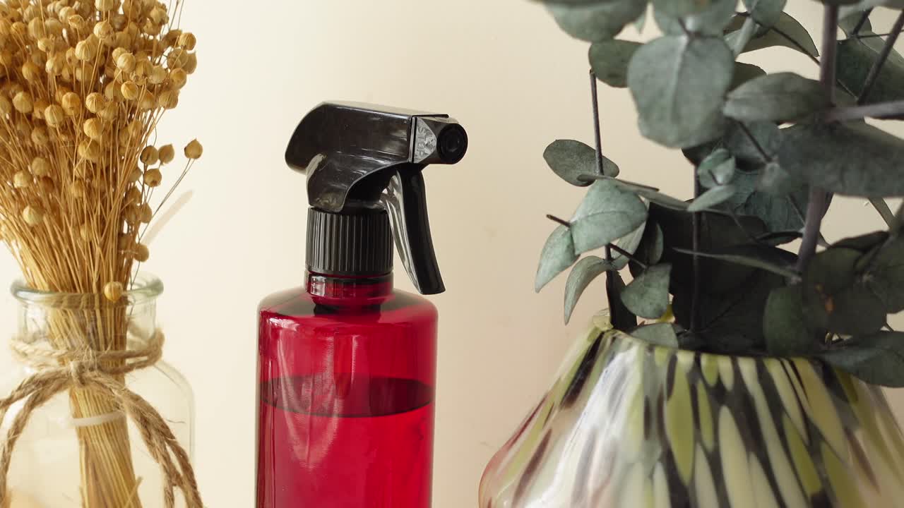 Spray bottle and vases with flowers