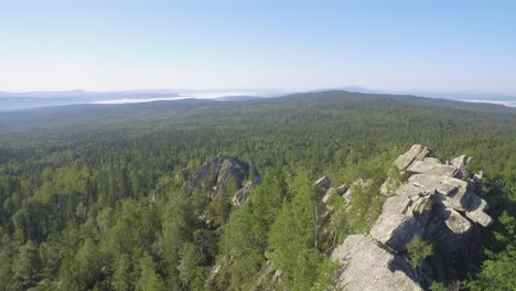 mountainous forest landscape with rocks and mist