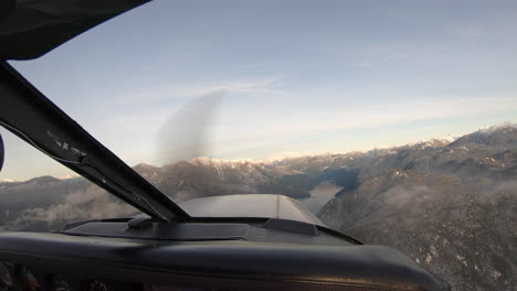 piper pa-28 cherokee plane flying above salmon inlet in sunshine coast, british columbia, canada