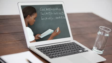 animation of a laptop showing biracial female teacher on the screen