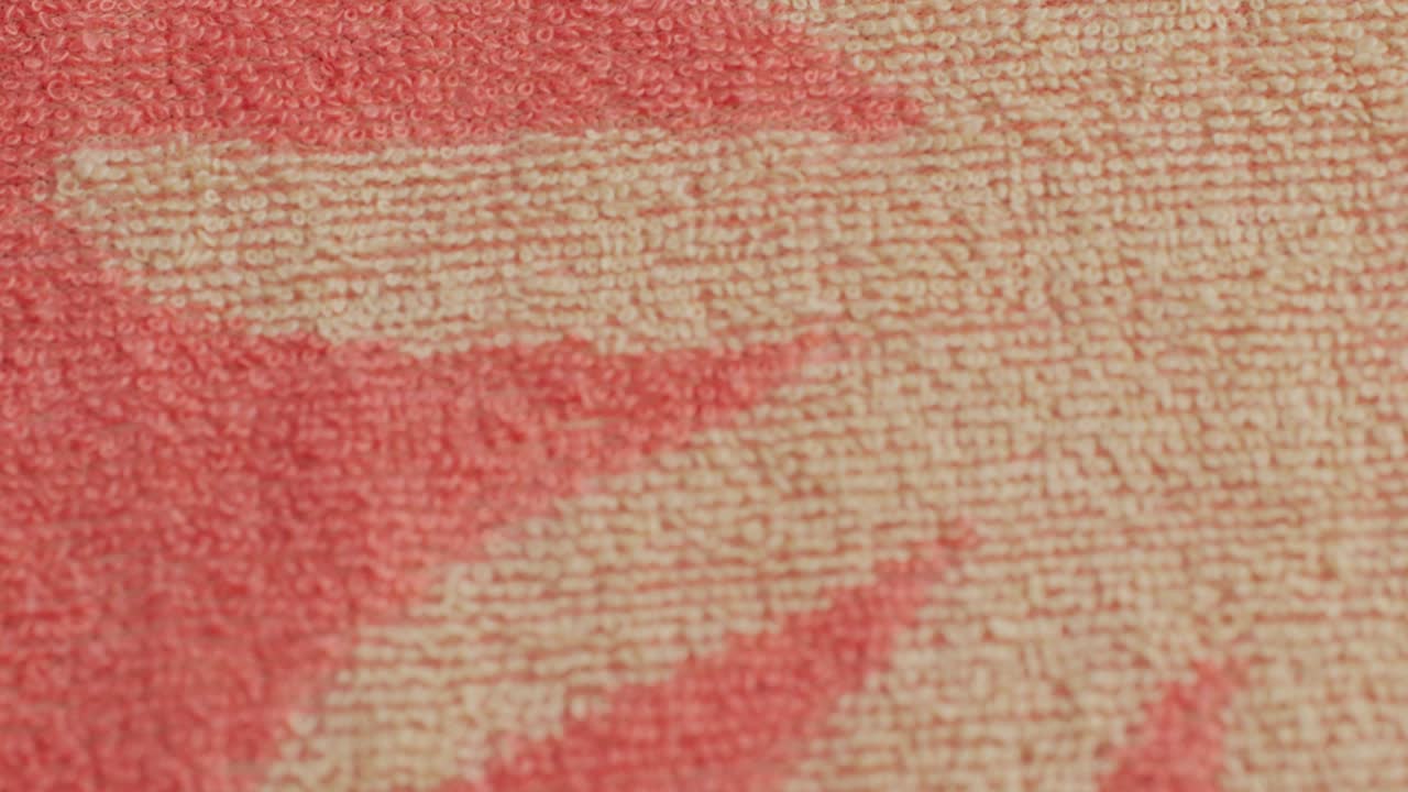 Pink color textile cloth texture close-up macro. Floral print. Fashion fabric multicolor.High quality 4k footage