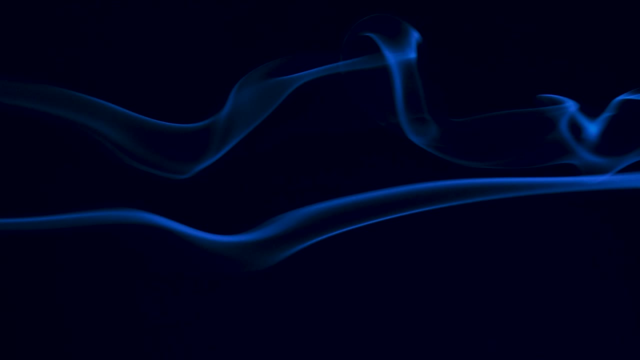 Fog or smoke on black background backlit with blue light. Free copy space. Close up. Slow motion