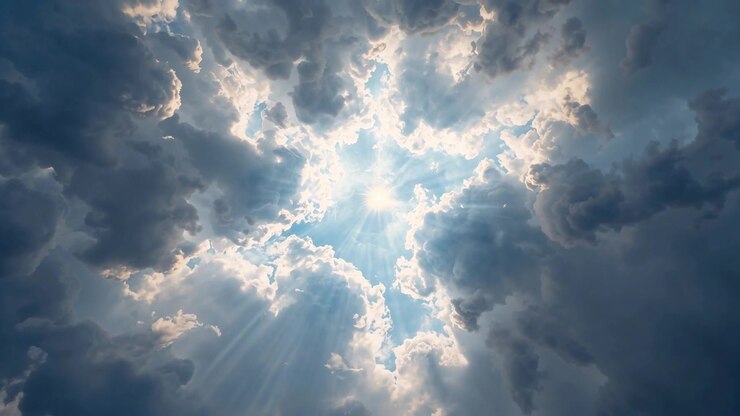 Revealing sun emerging through cloud gap, sunbeams streaming from ground sky, lighting cloud edges