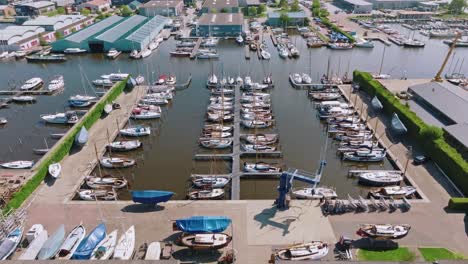 smooth drone shot zooming in while transitioning to top-down aerial of docked vessels