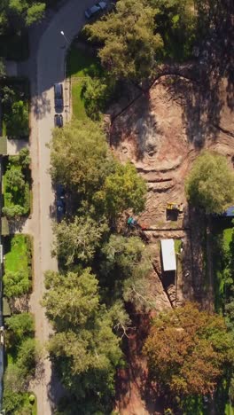 aerial top down of construction site with excavator and equipment for excavation
