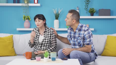 at home, the woman is nervous and her husband calms her down.