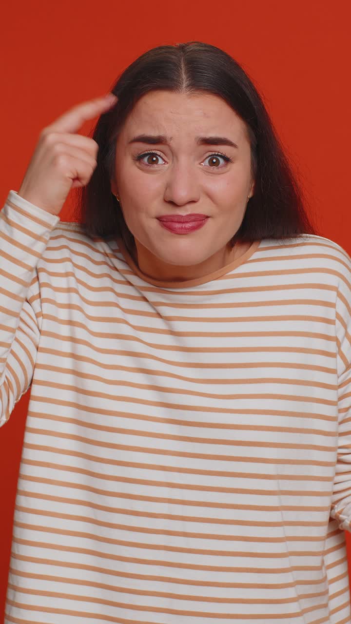 Woman pointing at camera and showing stupid gesture blaming some idiot for insane plan bullying