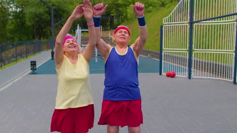 active senior sports team athletes putting arms hands together, cheering and ready to win, smiling