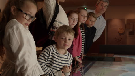 pupils on school trip to museum looking at map shot on r3d