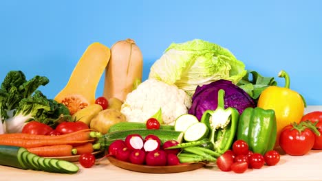 assorted vegetables arranged against a blue background