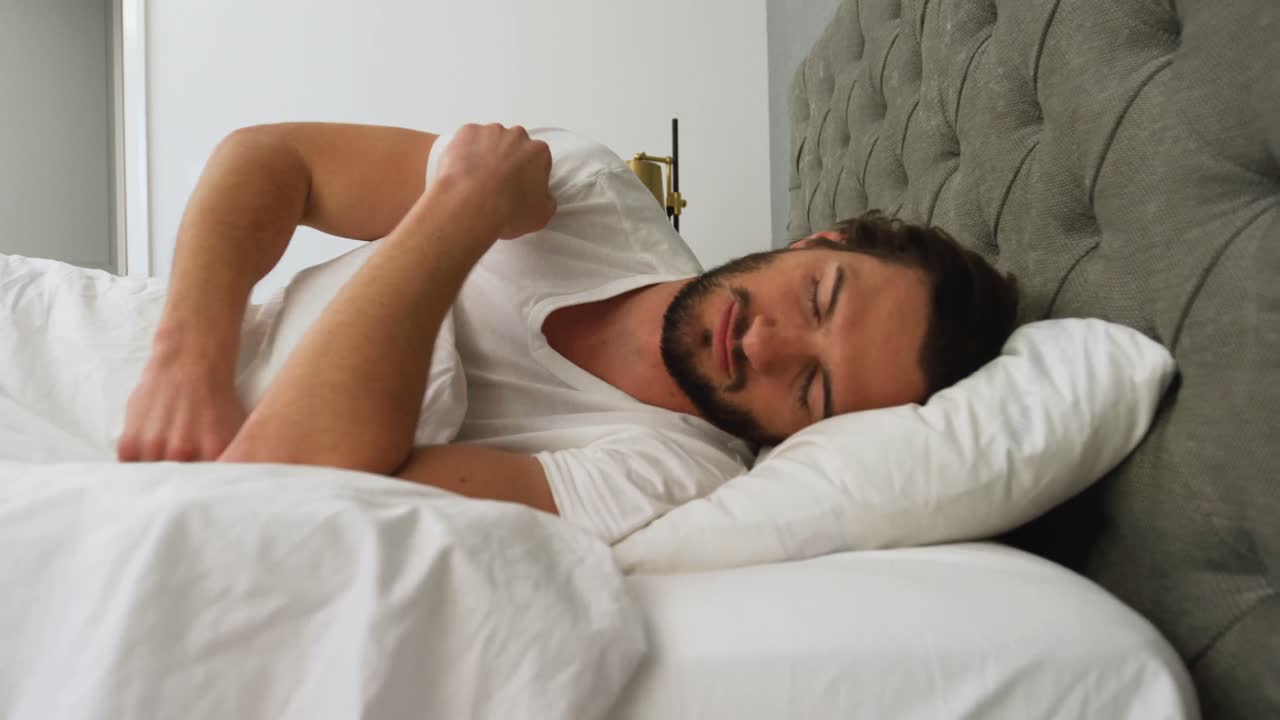un joven durmiendo en su cama.