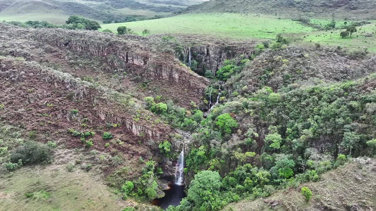 Drone view of a waterfall amidst cerrado vegetation in Serra da Canastra