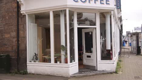 entrance-to-a-cute-coffee-shop-on-european-street-in-Inverness,-Scotland-in-the-Highlands