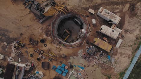 Repairing-an-underground-sewer-pipe-with-people-in-the-pit---top-down-rotation