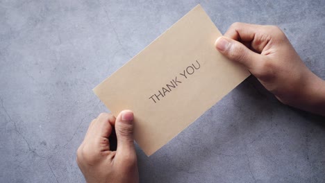 close up of man hand reading a thank you letter