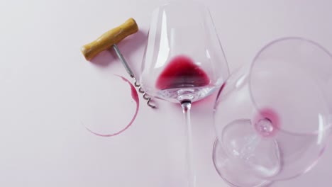 glasses with of wines and corkscrew lying on grey surface with copy space