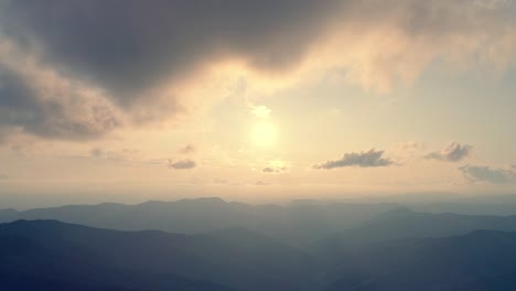 the flight above a mountain on the sunny background. hyperlapse