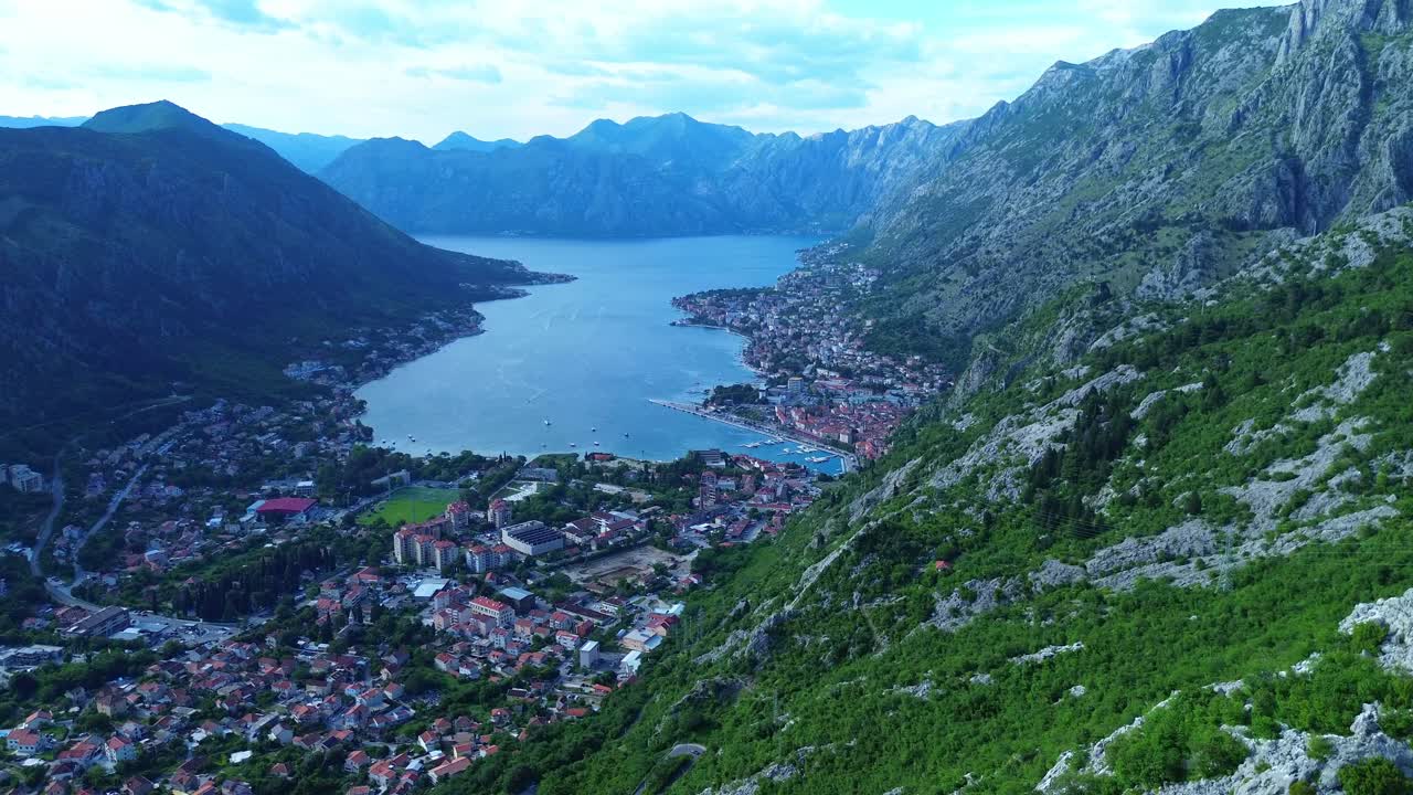 Mountainous and forested landscape surrounding the Bay of Kotor, lush green vegetation, Aerial