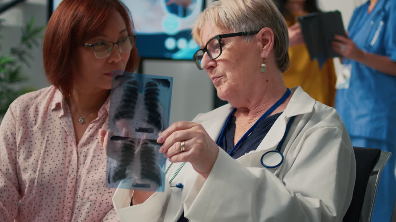 Doctor explaining X-ray results to patient in hospital waiting room