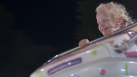 joyful and excited kid in the merry-go-round