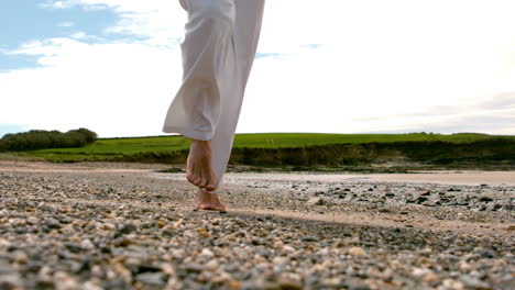 man jogging barefoot by the coast