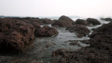 Waves-gently-flow-over-rocky-shore-during-sunset-creating-a-serene-coastal-landscape