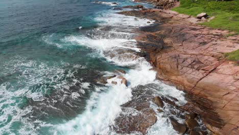 aerial view of waves breaking at the unpeopled coastline at anse songe on la digue, an island of the seychelles