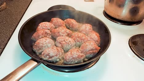 cooking meatballs in frying pan