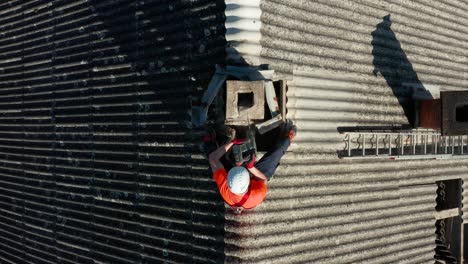 worker handling asbestos-contained materials on the roof