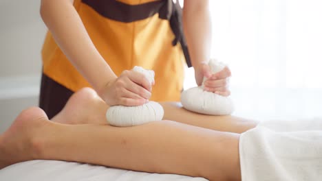 thai leg massage with herbal compresses