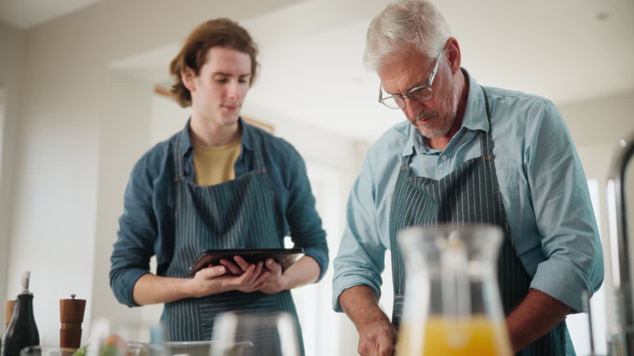 Father and son cooking together in the kitchen