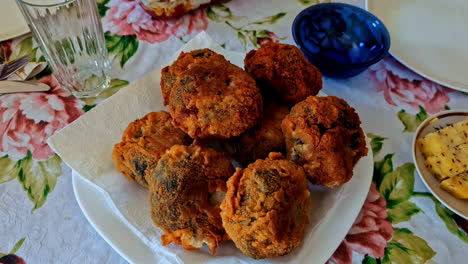 crispy homemade meatballs served on plate with floral tablecloth at lunch