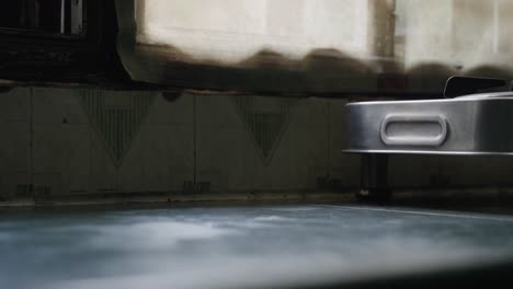 a close-up footage of a person's hand taking a glass of iced tea off a kitchen counter