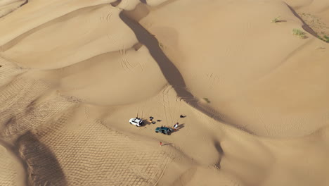 bird's-eye view of people in the gobi desert on a hot, sunny day