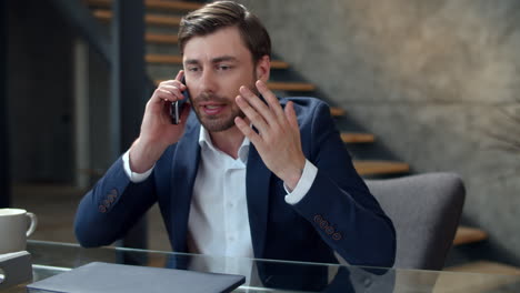 stressed businessman talking on phone emotionally. focused man calling phone.