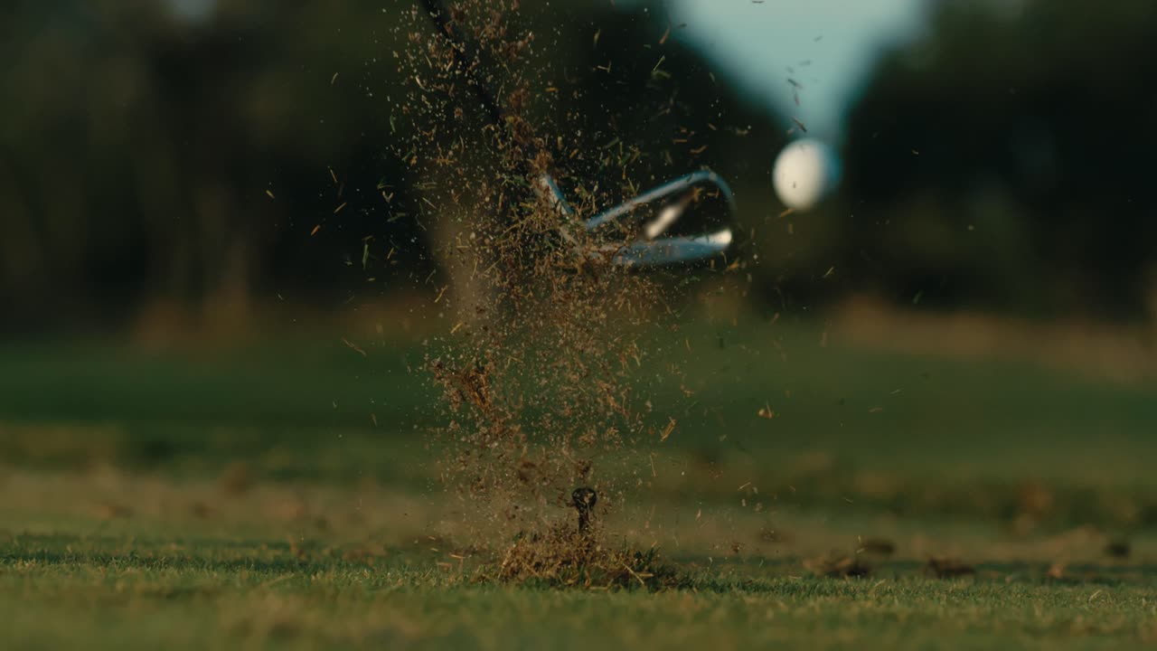Slow motion golf shot from behind, wedge shot from tee on par 3, perfect ball flight on sunny day