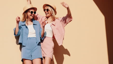 two happy women in trendy summer outfits