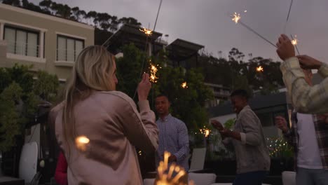 group of friends dancing together on a rooftop