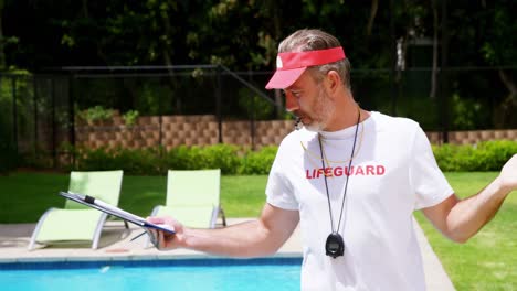 lifeguard holding clipboard and whistling