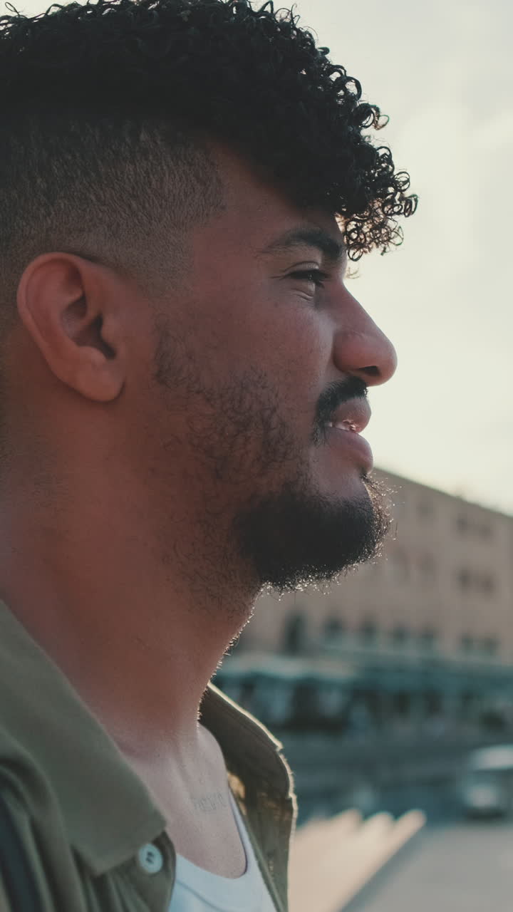 Portrait of a man with curly hair outdoors