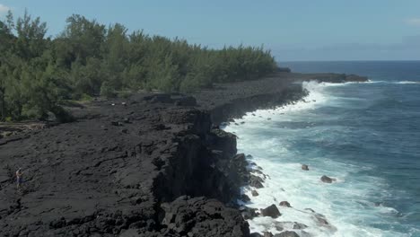 4k aerial fly-by lava cliff on tropical island