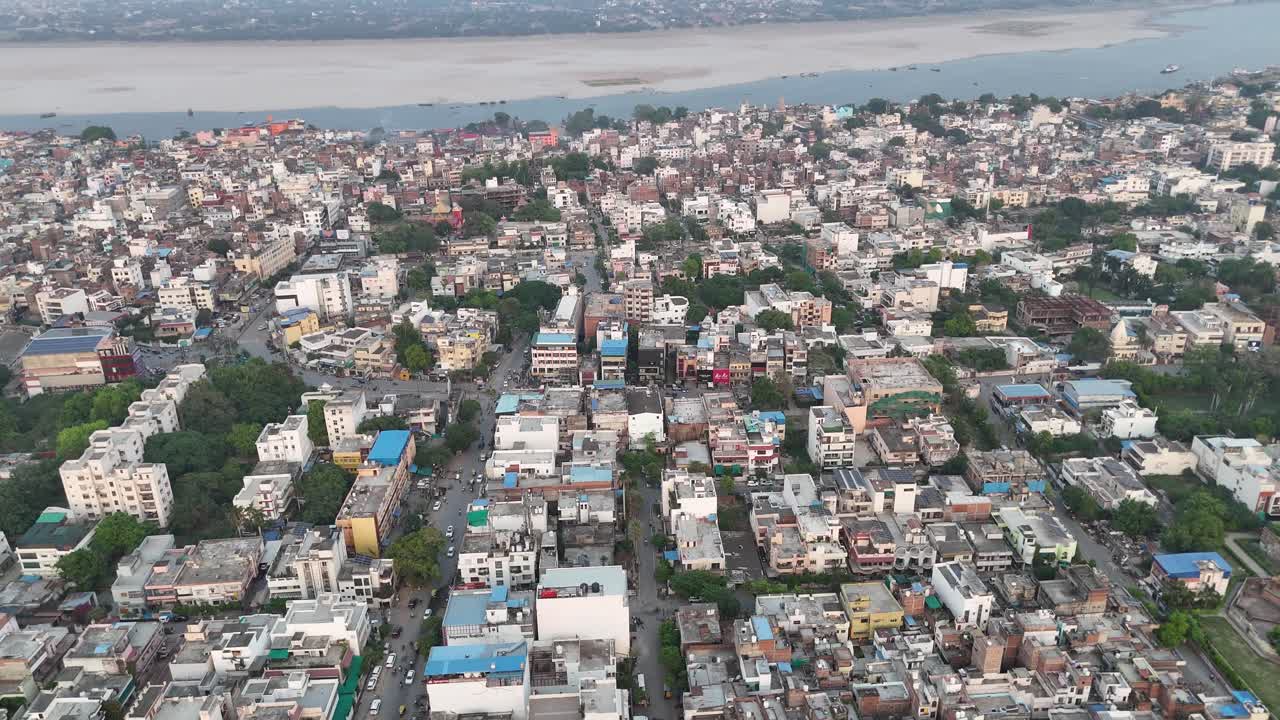 Dense residential neighborhood captured from above, revealing a vibrant mix of buildings, streets, and traffic in an Indian metropolitan area